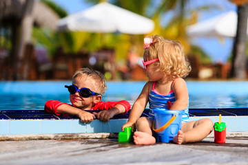 Fototapeta na wymiar little boy and girl playing in swimming pool