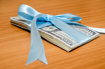 us dollar in blue ribbon on table