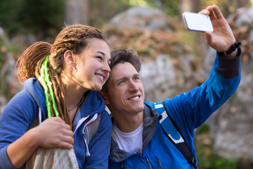Father and Daughter smiling and taking Photo with Mobile Telephone