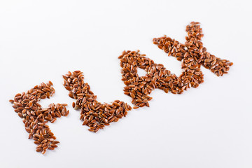 Word flax piled of flax seed on white background.