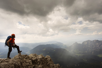 Man relaxing in Dolomites with via ferrata equipment / Dolomiti