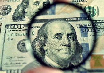 Dollar banknote through magnifying lens (corruption, lobbying, i