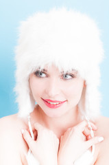 Beauty concept with smiling female model with fur hat