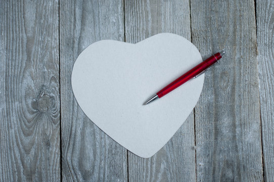 Heart shaped paper with pen