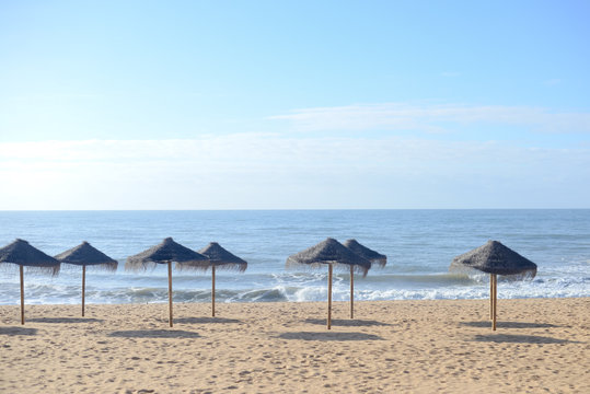 Exotic beach umbrellas and chairs on tropical coast © aquar