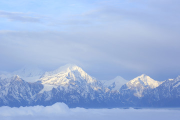 beautiful rolling clouds and frozen mountain summits landscape
