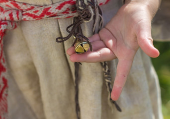 Little girl's hand with a bell