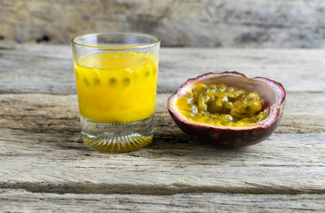 Passion fruits with glass of passion fruit juices on wooden
