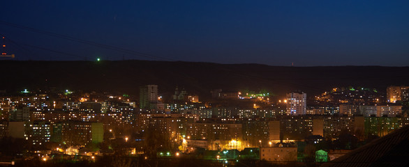 Naklejka premium Evening city lights and blue sky panorama