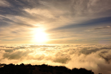beautiful rolling clouds and sunrise on mountain summits landscape