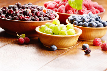 Wooden bowls with organic berries