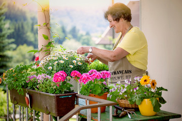 senior woman with flowers on balcony/gardening 08