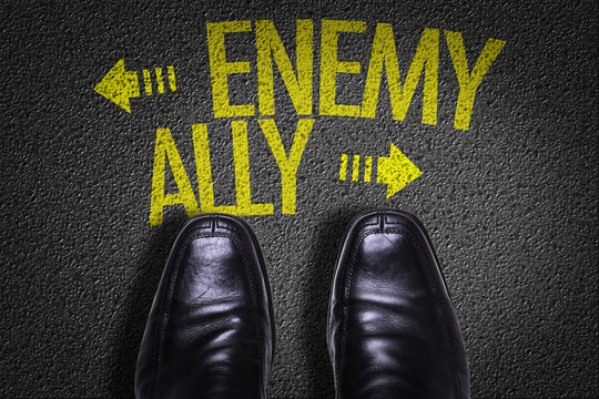 Top View of Business Shoes on the floor with the text: Enemy - Ally