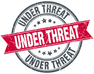 under threat red round grunge vintage ribbon stamp