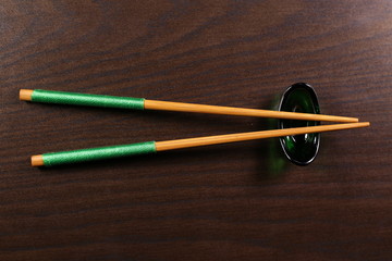 Japanese chopsticks isolated on brown background
