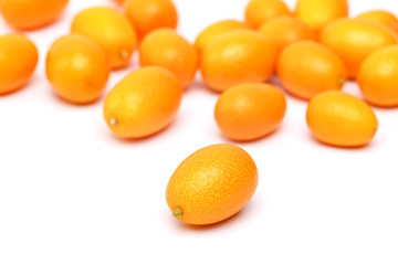 raw kumquat on a white