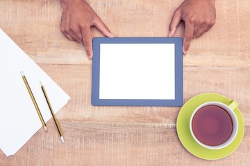 Cropped image of man with digital tablet over table