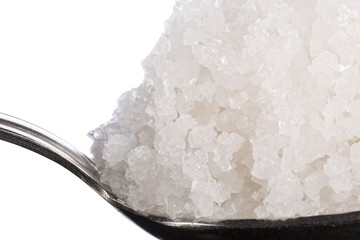 Sea salt crystals large in spoon macro. Side view.