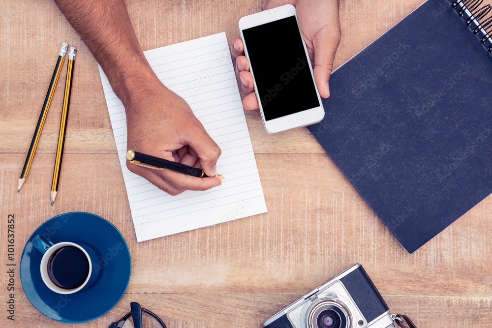 Poster high angle view of businessman writing on notepad