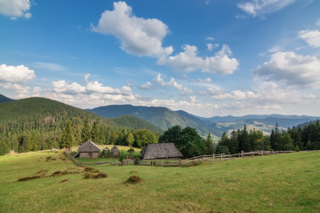 Wooden houses in the Carpathian Mountains with views of the mountains. Ukraine Synevir.