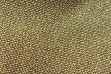 Gold tread on fabric, golden background