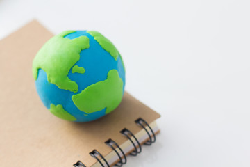 Earth on notebook on white background, Knowledge around the world.