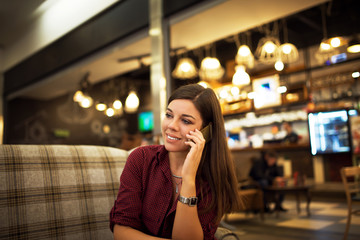 Beautiful young woman talking on smart phone.