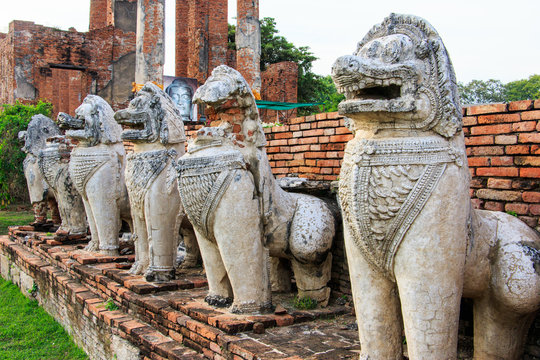 Antique Stupa surrounded by Lion statue cambodia style in Thammikarat Temple in Ayutthaya, Thailand