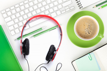 Coffee cup, headphones and office supplies