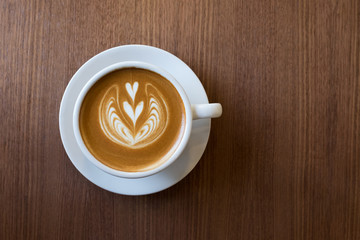 Coffee cup with milk and heart shape