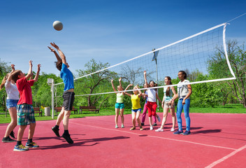 Jumping boy during volleyball game on the court