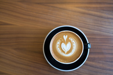 Coffee cup with milk and heart shape