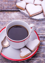 Coffee cup and biscuits, cookies in the shape of heart on wooden background. St.Valentines Day.