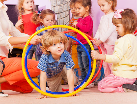 Nice Boy Play With Hoops In Kindergarten Goup