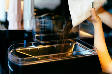 Closeup of barista grinding coffee