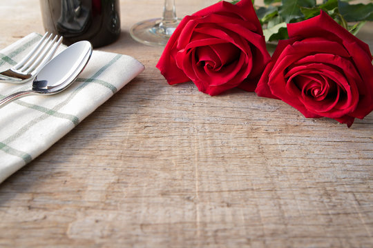 Red roses on dining table.  Valentine's Day, anniversary etc.