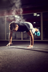 
Handsome athlete working extreme push ups. Shallow depth of field.