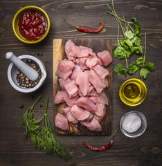 raw turkey with vegetables and spices on wooden rustic background top view close up
