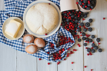 Ingredients for baking sweet cakes with berries.