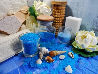 Obraz na płótnie Canvas Spa in the colors blue - Aromatic soap, scented bath salt, and oil, and accessories for massage and bath 