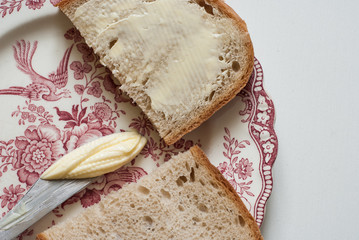 Tasty buttered bread on the vintage plate