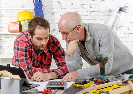 two technicians read plan in the workshop