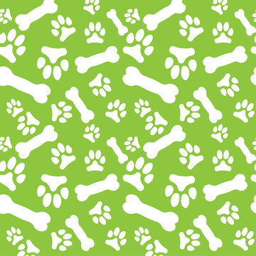 Seamless Pattern With White Dog Paw Prints And Bones On A Green Background