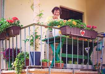 elderly woman with her flowers on balcony/gardening 11