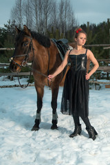Fototapeta premium woman posing with a horse in the winter forest