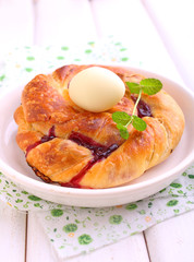 Easter buns with chocolate eggs on wooden background