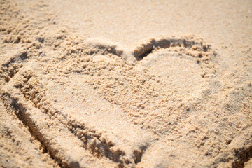 Fototapeta na wymiar Love heart drawn on the sand of a beach