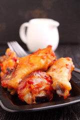 Chicken wings fried with spices in tomato sauce