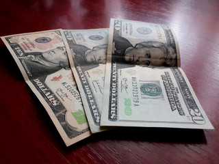 Dollars/Dollar banknotes laying on the table