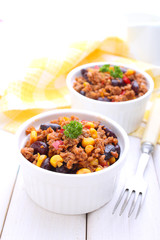 minced meat with corn, sweet peppers and beans in a dish